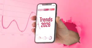 Smartphone con gráficos de crecimiento y el texto Trends 2026, ilustrando las tendencias del marketing digital para el futuro en Wolf Publicidad.